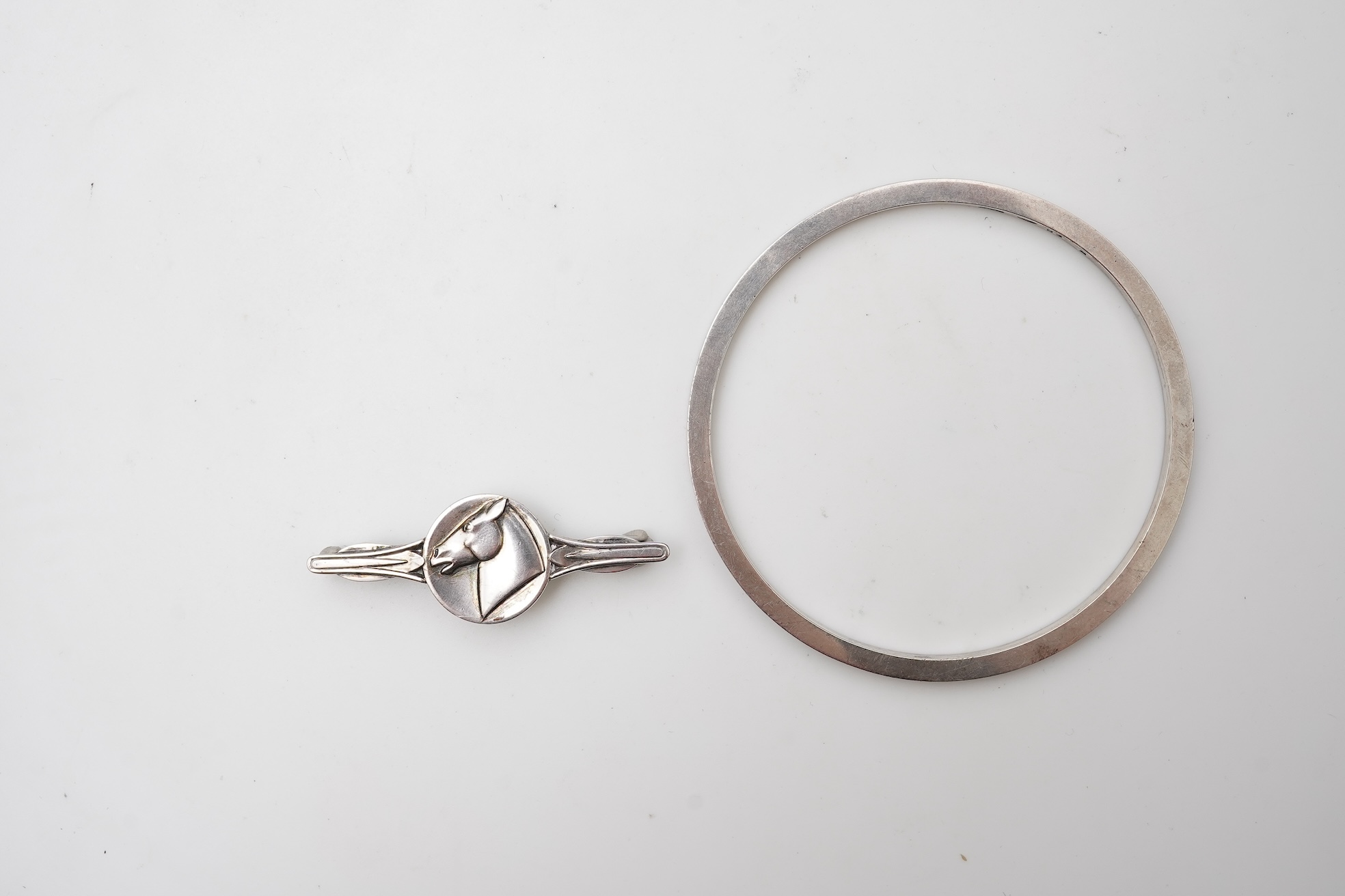 Georg Jensen, a bangle, circa 1964, and brooch, second half 20th century